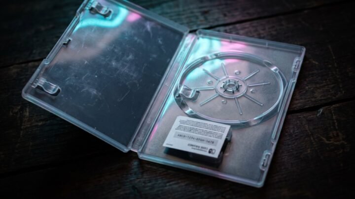 Open empty game case with no disc, only a download code card inside